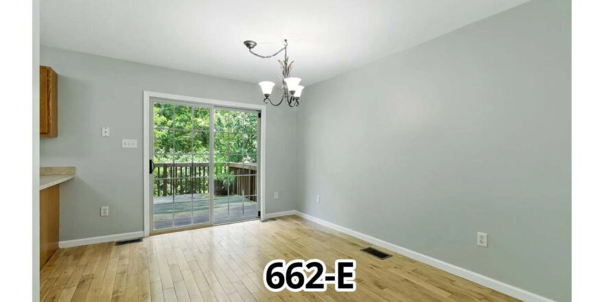 an empty room with a door and a window