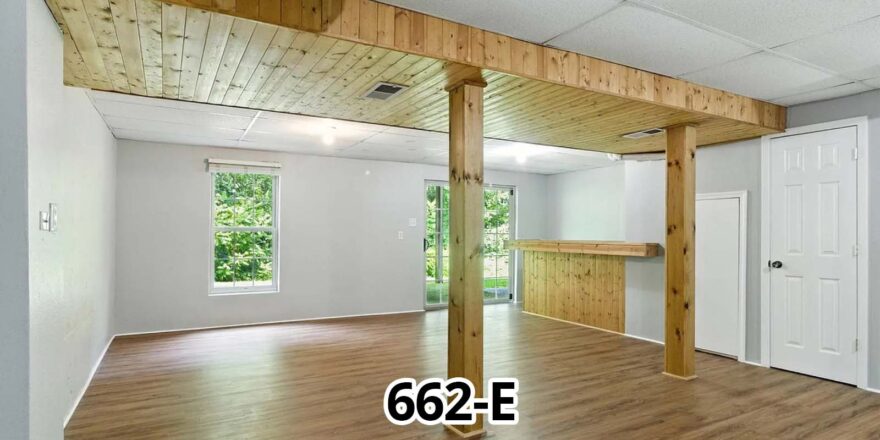 an empty living room with wood floors and white walls