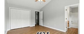 an empty room with a ceiling fan and hard wood floors