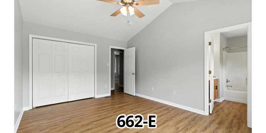 an empty room with a ceiling fan and hard wood floors