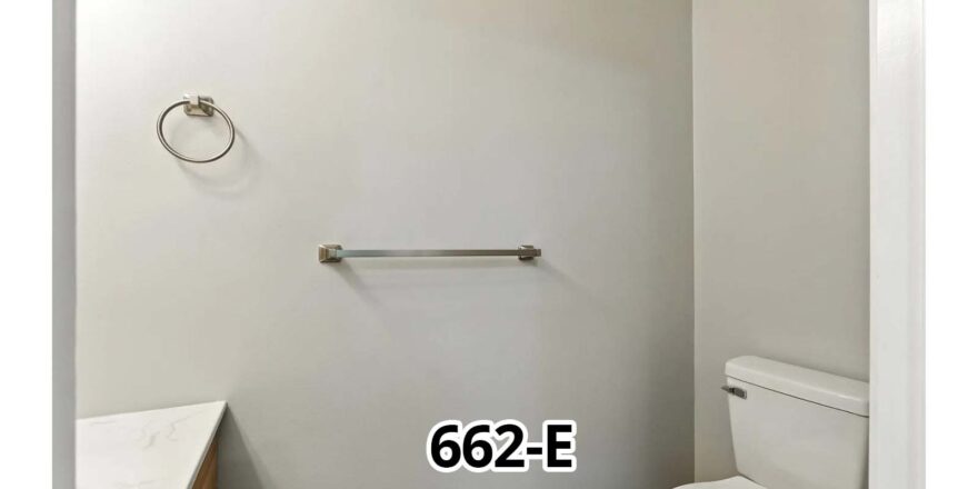 a white toilet sitting next to a white sink