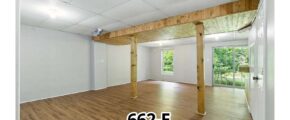 an empty room with wood floors and white walls