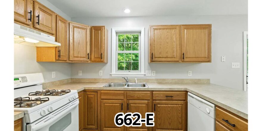 a kitchen with a white stove top oven next to a window