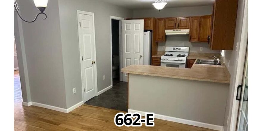 an empty kitchen and living room in a house