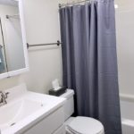 Bathroom with vanity, medicine cabinet, toilet, and shower and tub combo