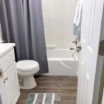 Bathroom with vanity, medicine cabinet, toilet, and shower and tub combo