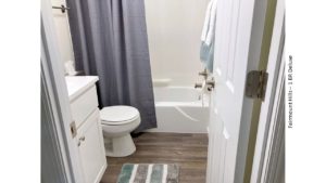 Bathroom with vanity, medicine cabinet, toilet, and shower and tub combo