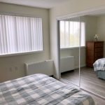 Bedroom with large closet, dresser, and full-size bed