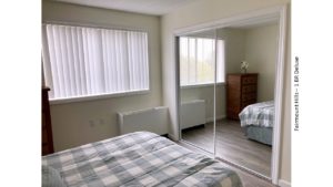 Bedroom with large closet, dresser, and full-size bed