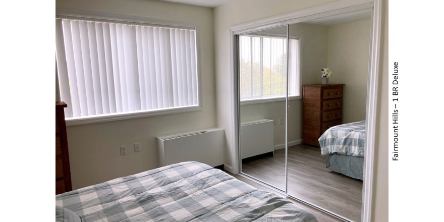 Bedroom with large closet, dresser, and full-size bed