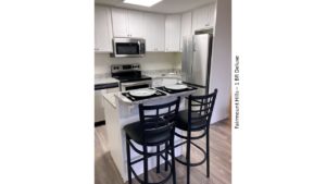 Kitchen with white cabinets, stainless steel appliances and granite-style counter tops