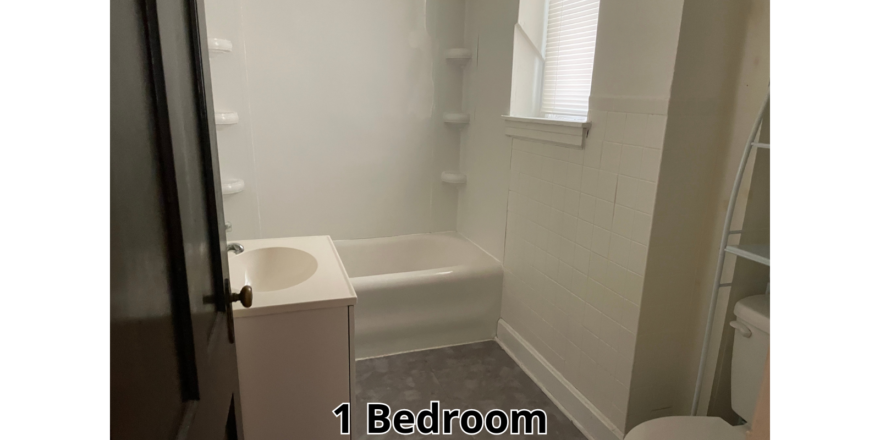 a bathroom with a toilet, sink, and bathtub