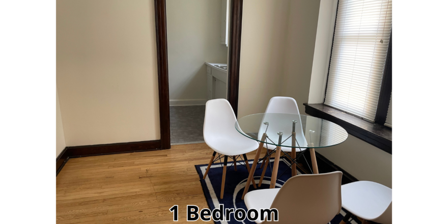 a room with a table, chairs and a mirror