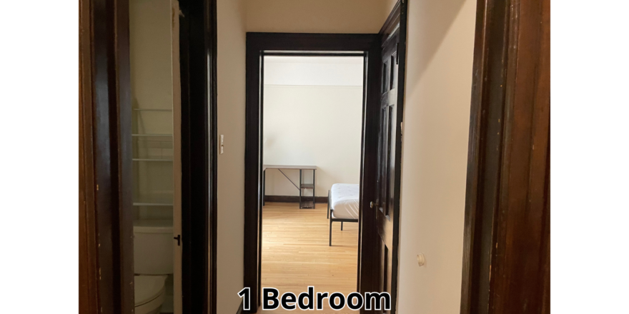 a hallway leading to a bedroom in a house