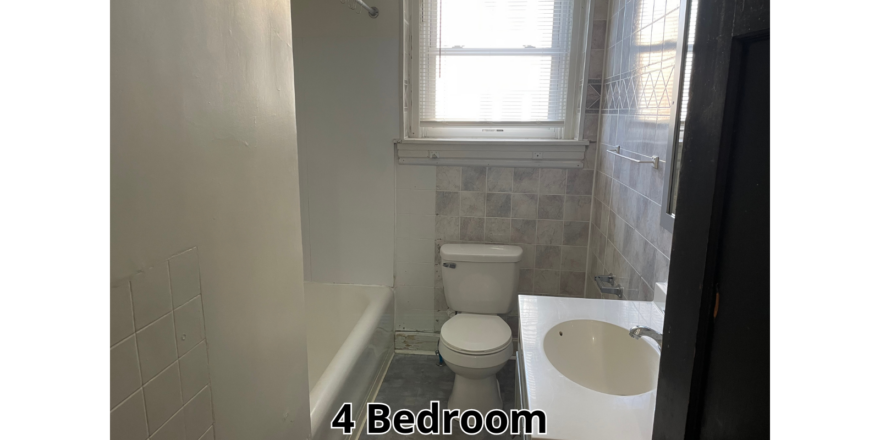 a bathroom with a sink, toilet and window