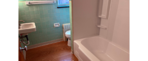 a bathroom with a tub, toilet and sink
