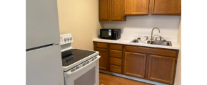 a kitchen with a refrigerator, stove and sink
