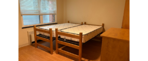 a bedroom with a bed and a desk in it