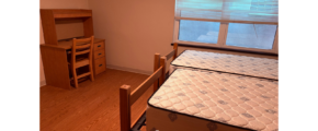 a bedroom with a bed, desk and chair