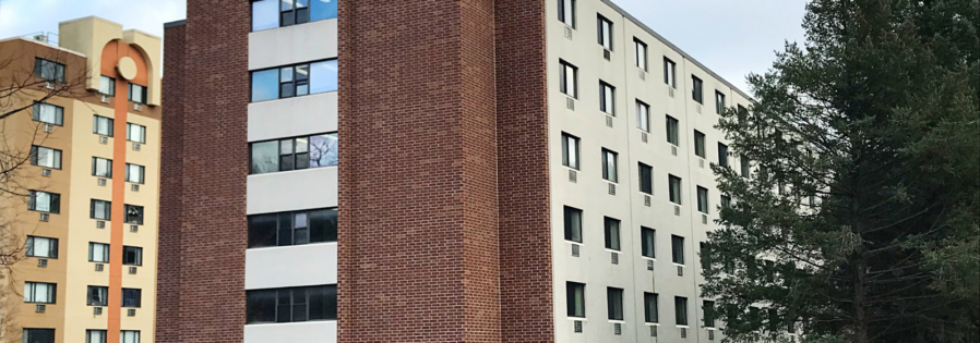 a tall building with a clock tower in front of it