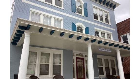 a blue and white house with columns and windows