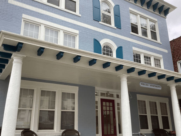a blue and white house with columns and windows