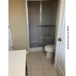 a bathroom with a toilet, shower and sink