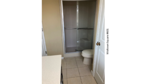 a bathroom with a toilet, shower and sink