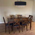 a dinning room table with chairs and a chandelier