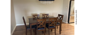 a dinning room table with chairs and a chandelier