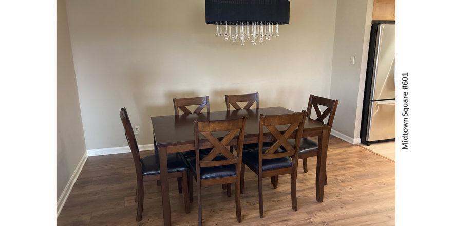 a dinning room table with chairs and a chandelier