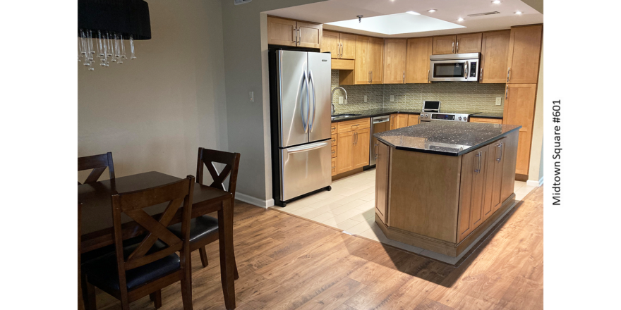 a kitchen with a center island in the middle of it