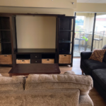 a living room with couches and a flat screen tv