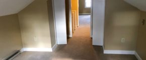 Carpeted attic flex room with two small closets