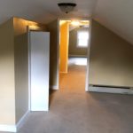 Carpeted attic flex room with built in drawers and small closet