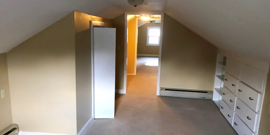 Carpeted attic flex room with built in drawers and small closet