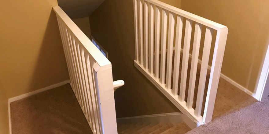 Carpeted stairwell from the top of the steps