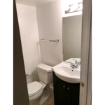 Basement bathroom with toilet and vanity