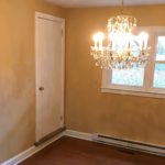 Dining room with chandelier and doorway to attic flex space