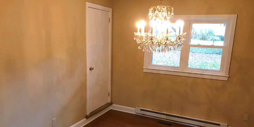 Dining room with chandelier and doorway to attic flex space