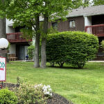 Galenwood sign in front of the brown and white building with red-brown painted balconies