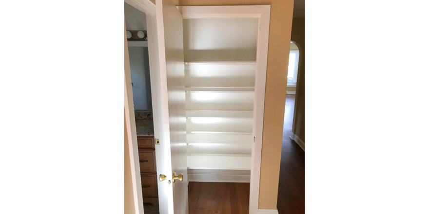 Hallway closet with built-in shelving