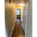 Hallway with laminate, hardwood-style flooring