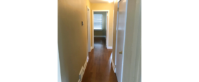 Hallway with laminate, hardwood-style flooring
