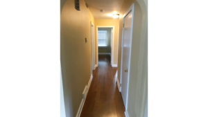 Hallway with laminate, hardwood-style flooring