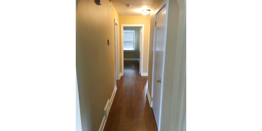 Hallway with laminate, hardwood-style flooring