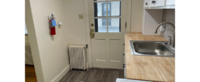 a kitchen with a stove top oven next to a sink