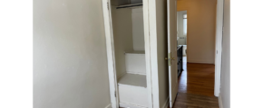 an empty room with a closet and a door