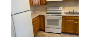 a kitchen with a white stove top oven