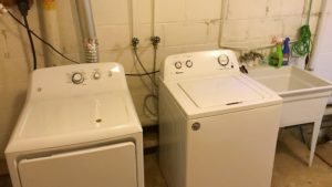 Laundry room with washer, dryer, and laundry tub